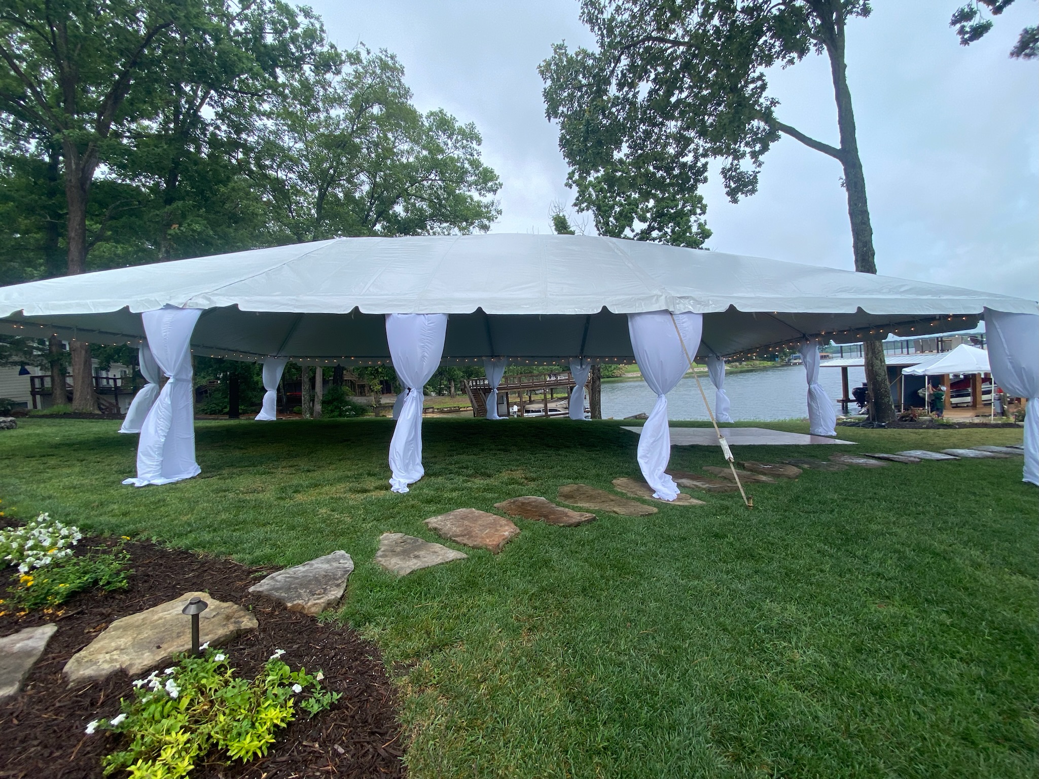 Tent Rentals Lakeside with pole draping and lighting rentals